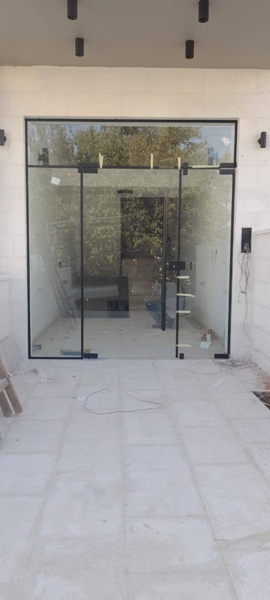 Glass storefront entrance with black frame