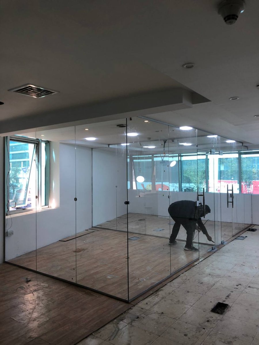 Full glass room partition in commercial space