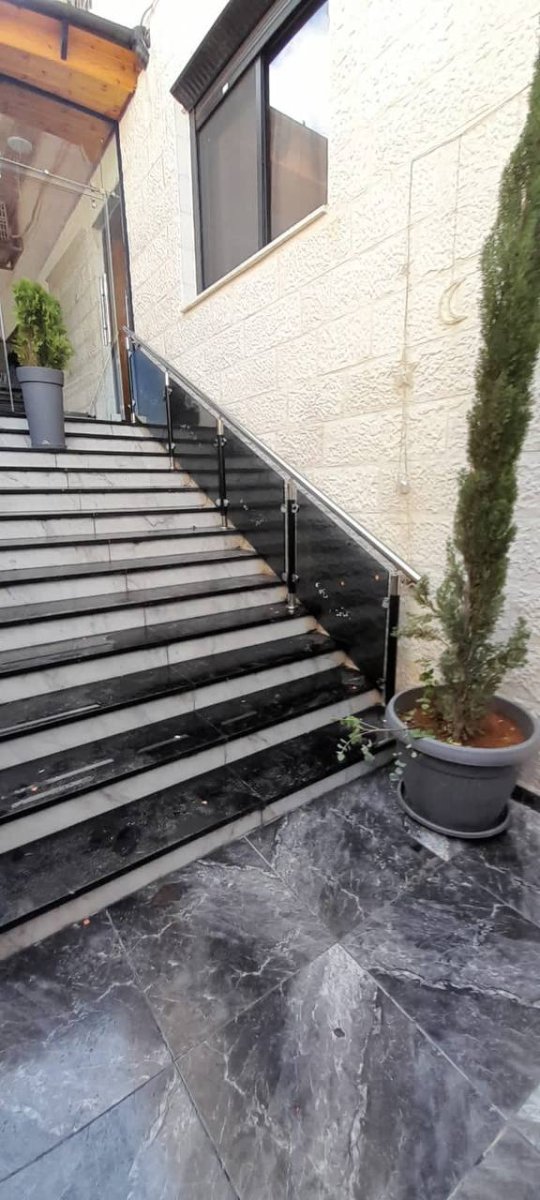 Exterior glass railing on stone staircase