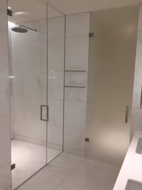 Frameless glass shower enclosure installation